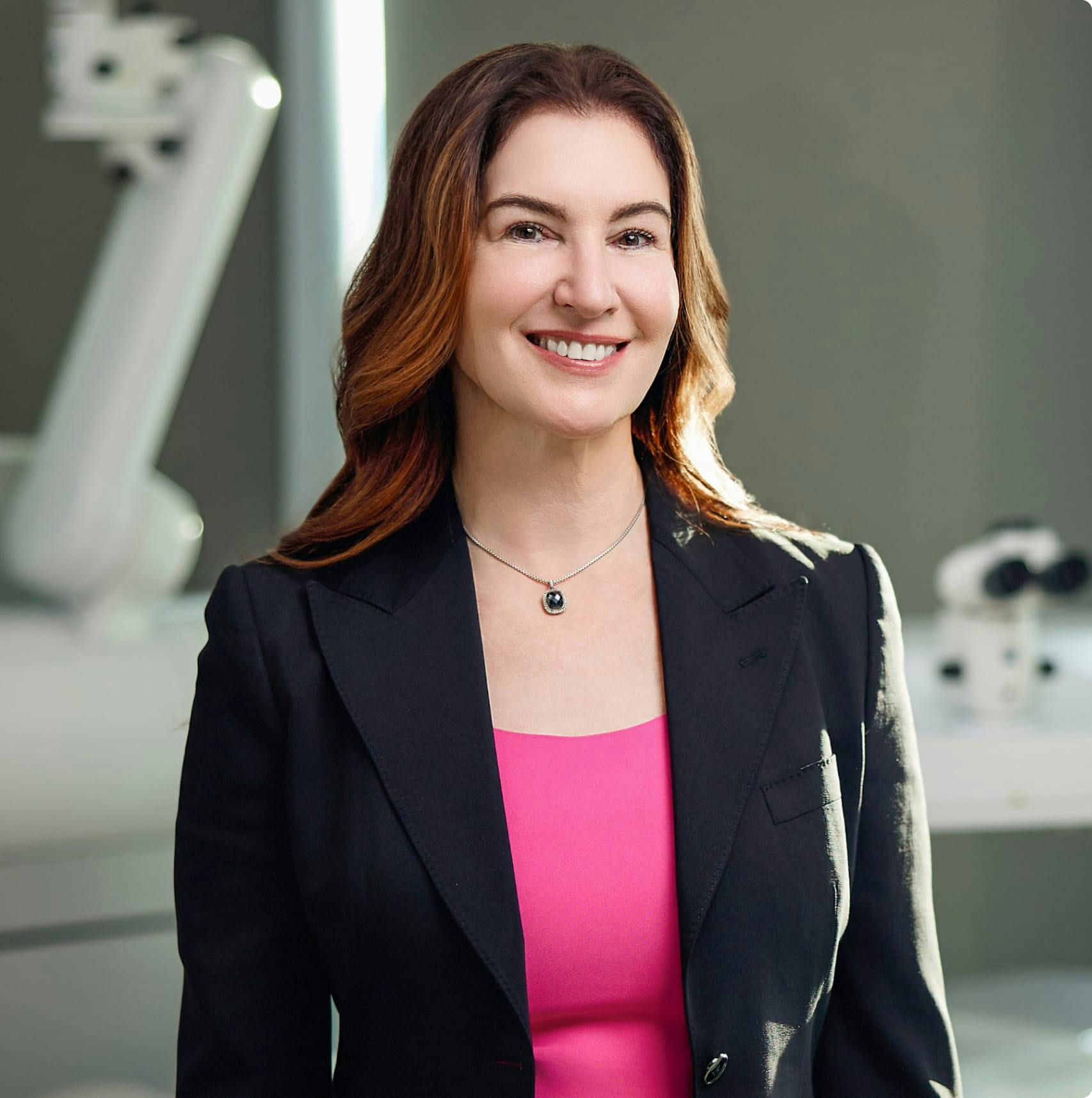 Dr. Rostov in a suit with a magenta top