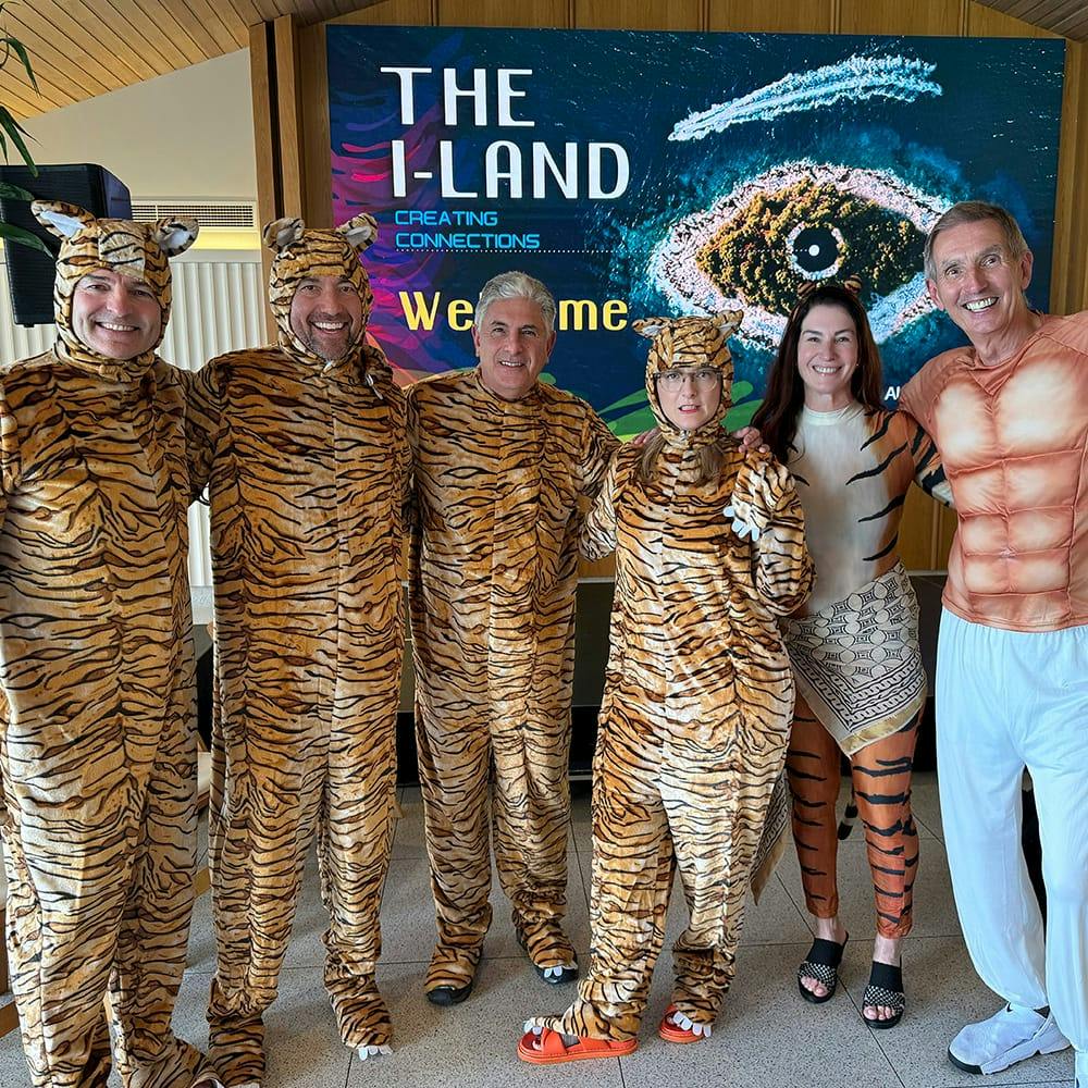 doctor posing with people in tiger costumes
