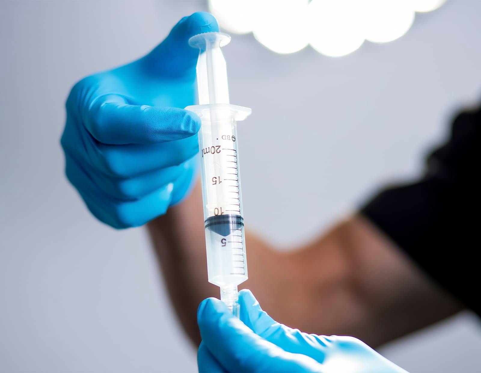 Medical professional preparing a syringe