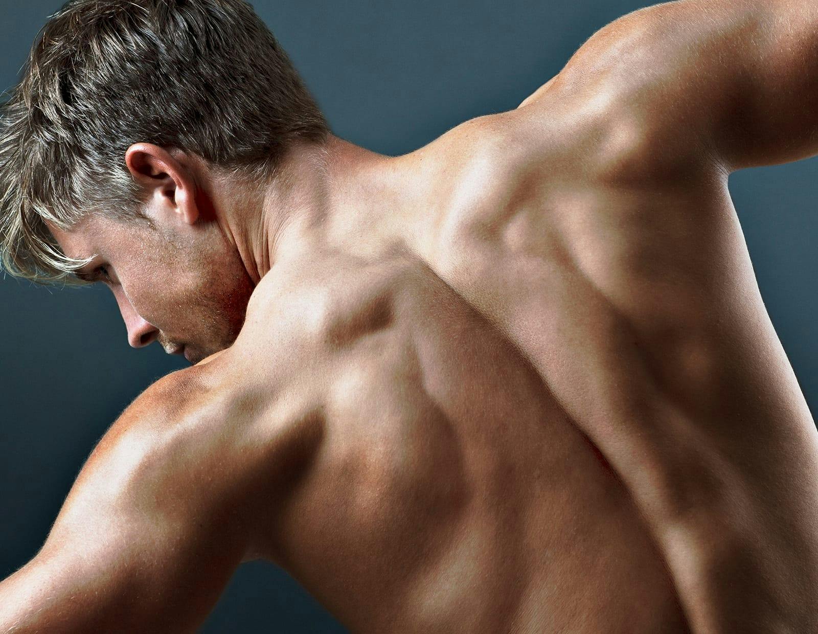 Muscular man's back with arms stretched