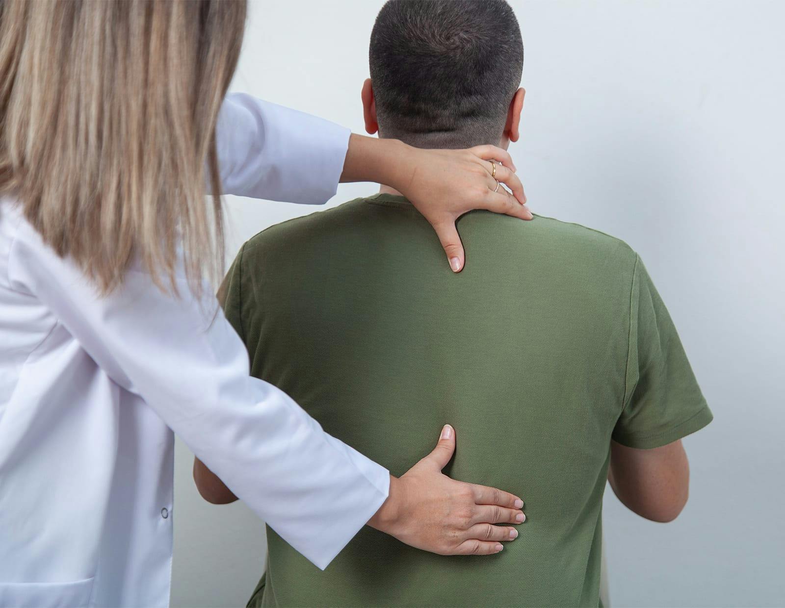 Medical professional examining a patient's lower back