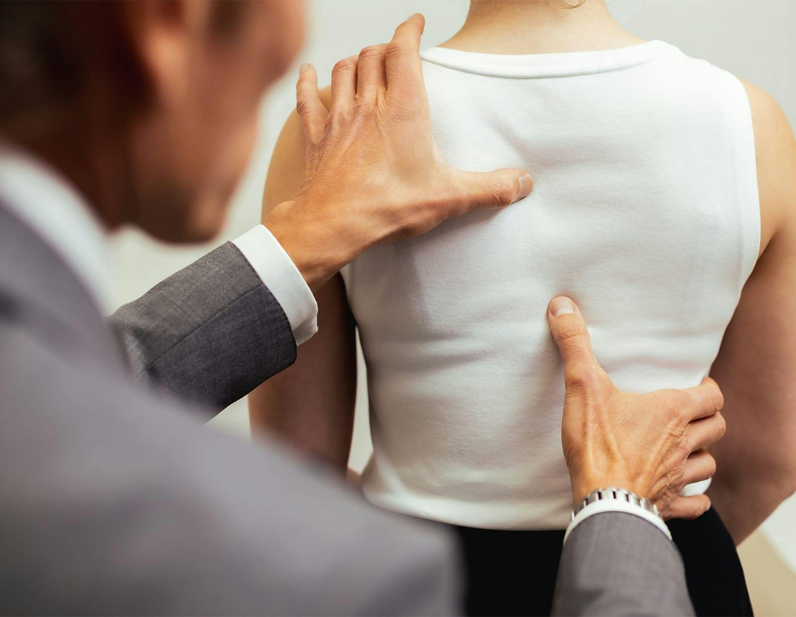 Dr. Michael Gerling examining a patient's back