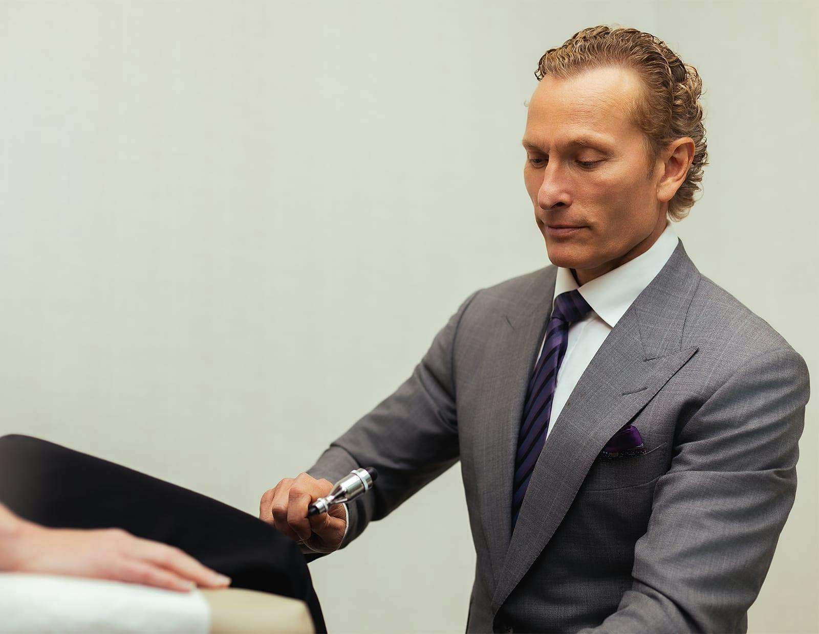 Dr. Gerling performing a neurological reflex test on a patient