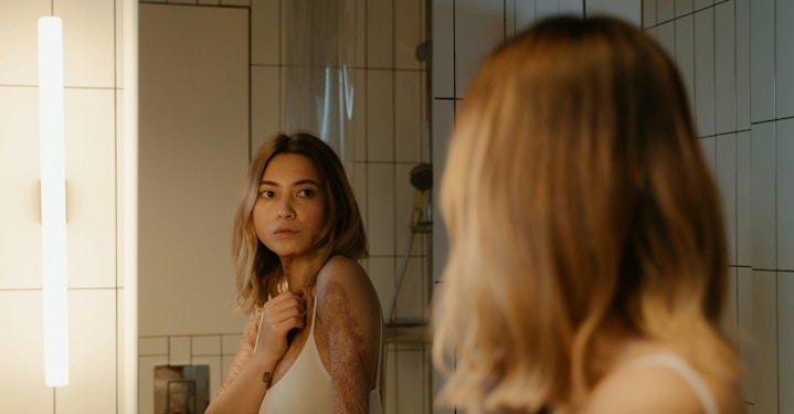 Person looking at reflection in mirror