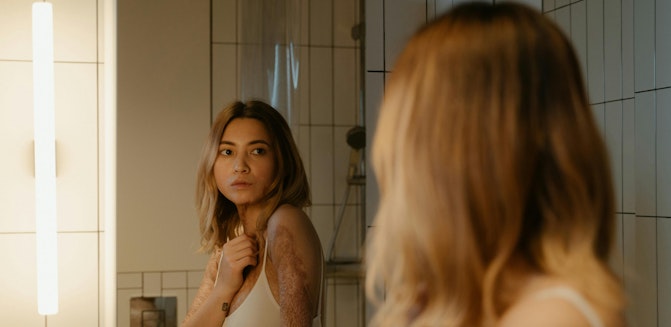 Person looking at reflection in mirror