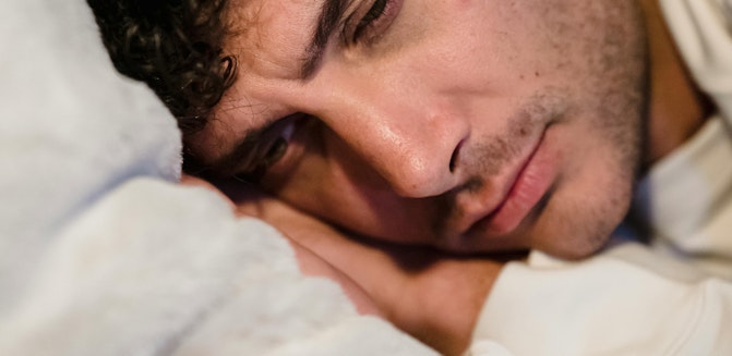 Person potentially contemplating sobriety while resting on a pillow