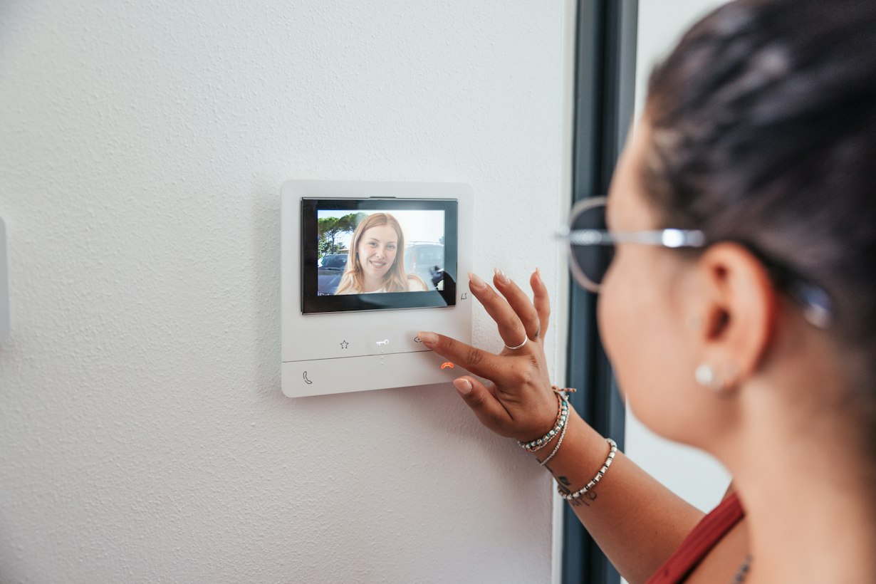 Answering a video door intercom and seeing the visitor on screen