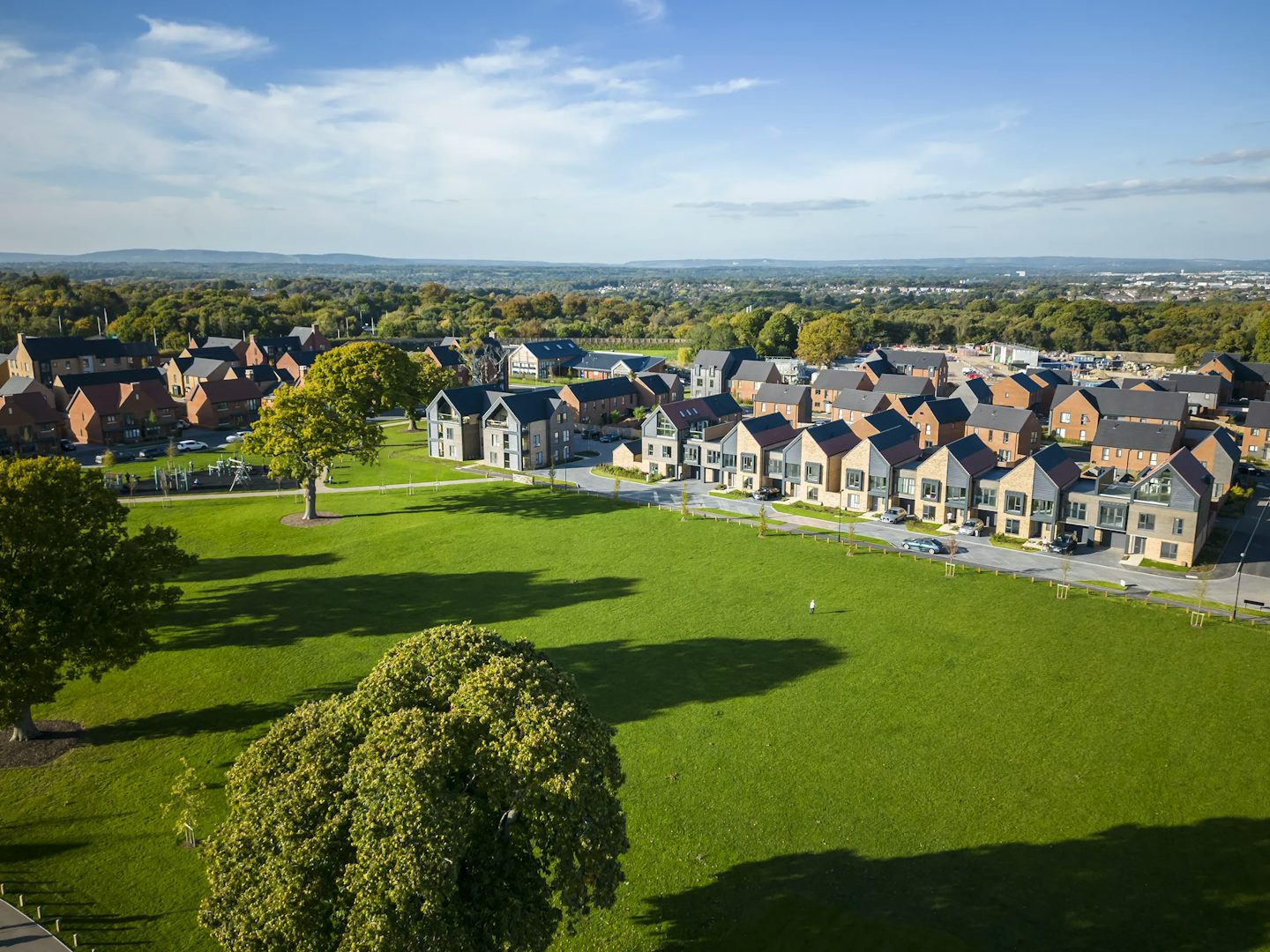 A row of nordic style villas on the village green by Thakeham at Woodgate at Pease Pottage.