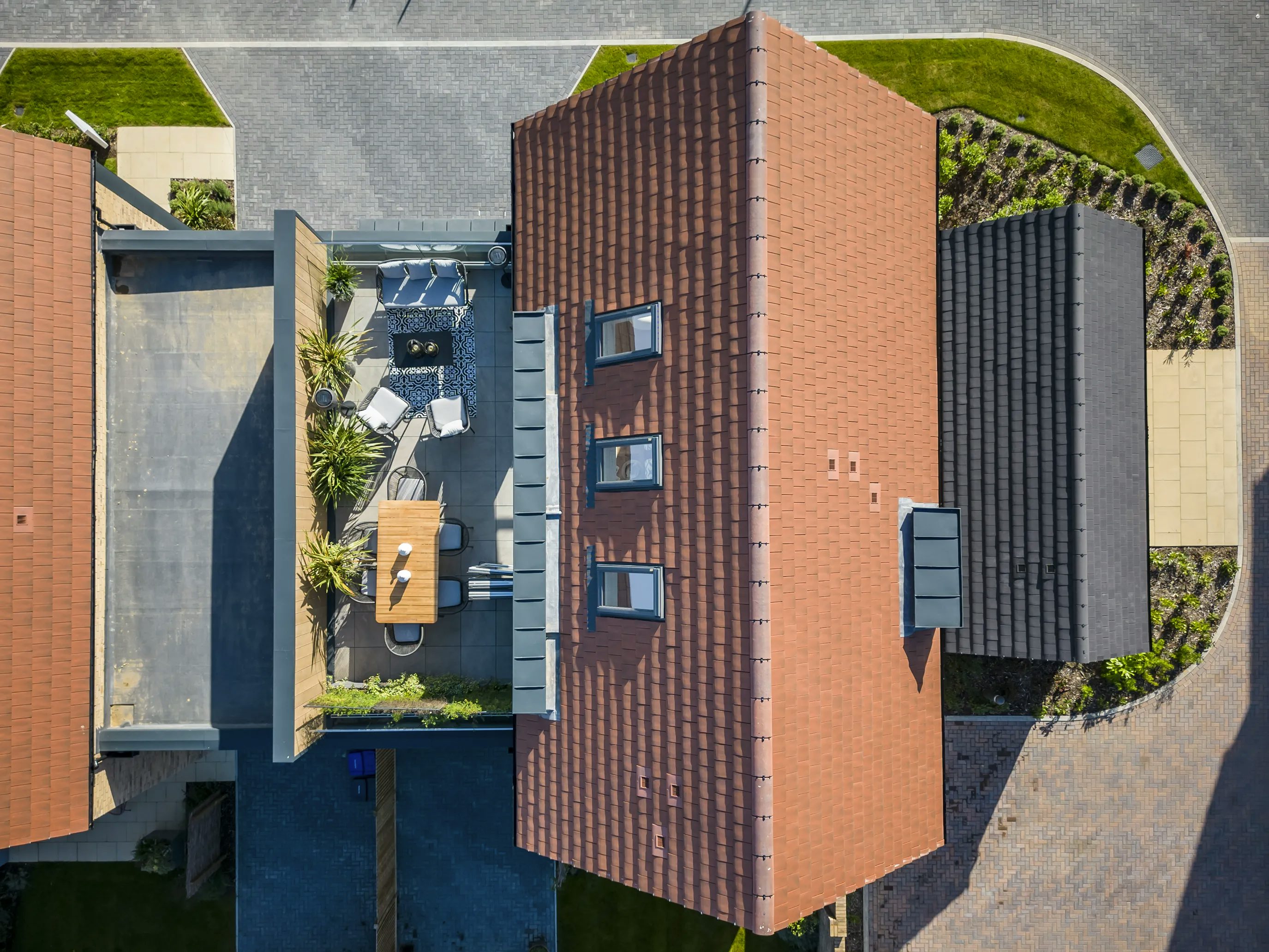 Aerial view of a nordic style villa with roof terrace at Woodgate at Pease Pottage