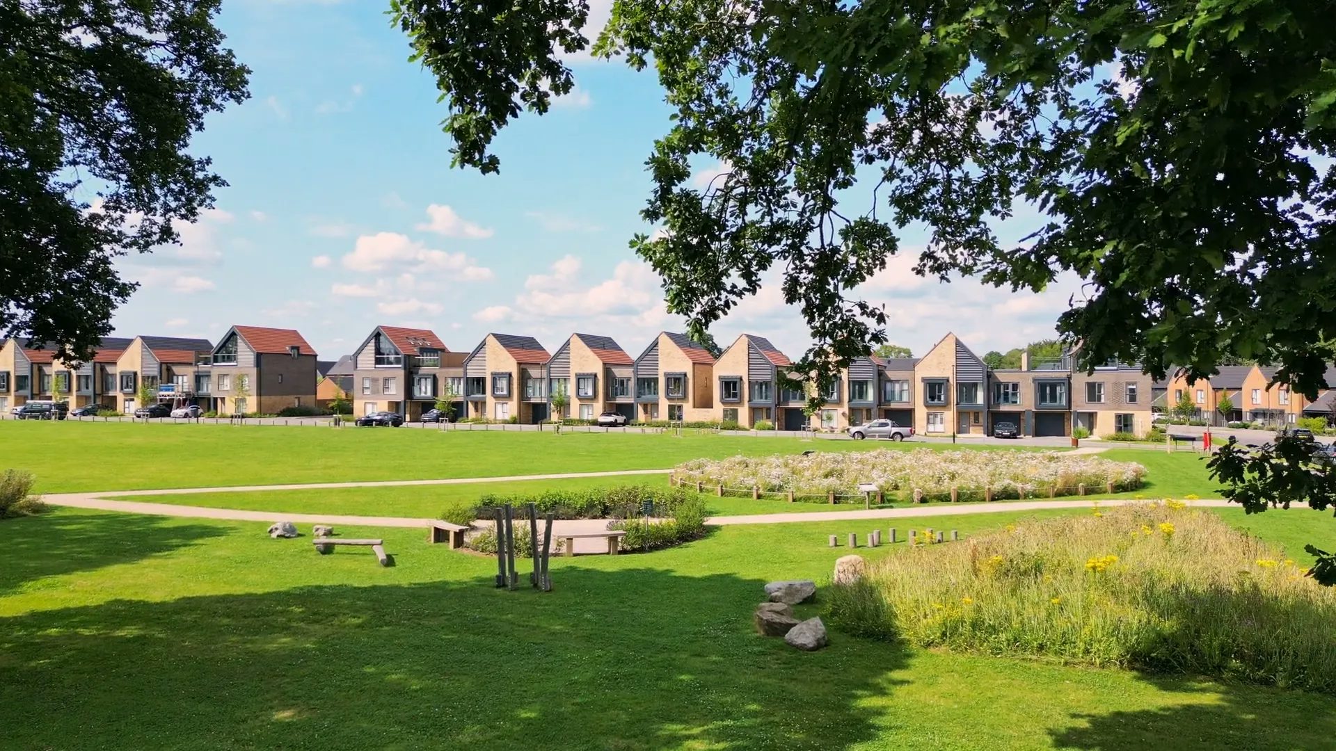 A row of nordic style villas line the village green at Woodgate at Pease Pottage.