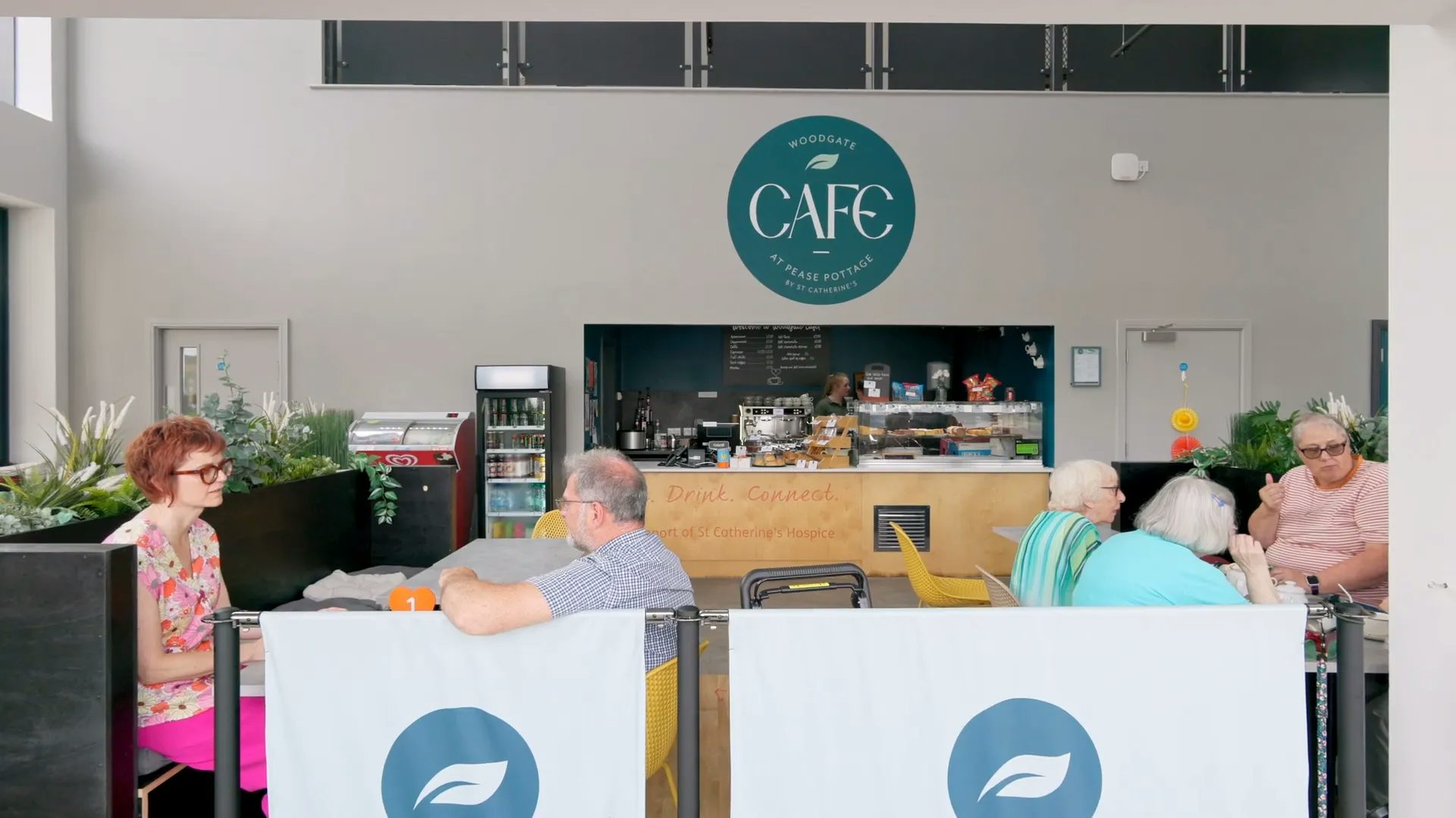 People eat lunch and pastries at the Woodgate Cafe