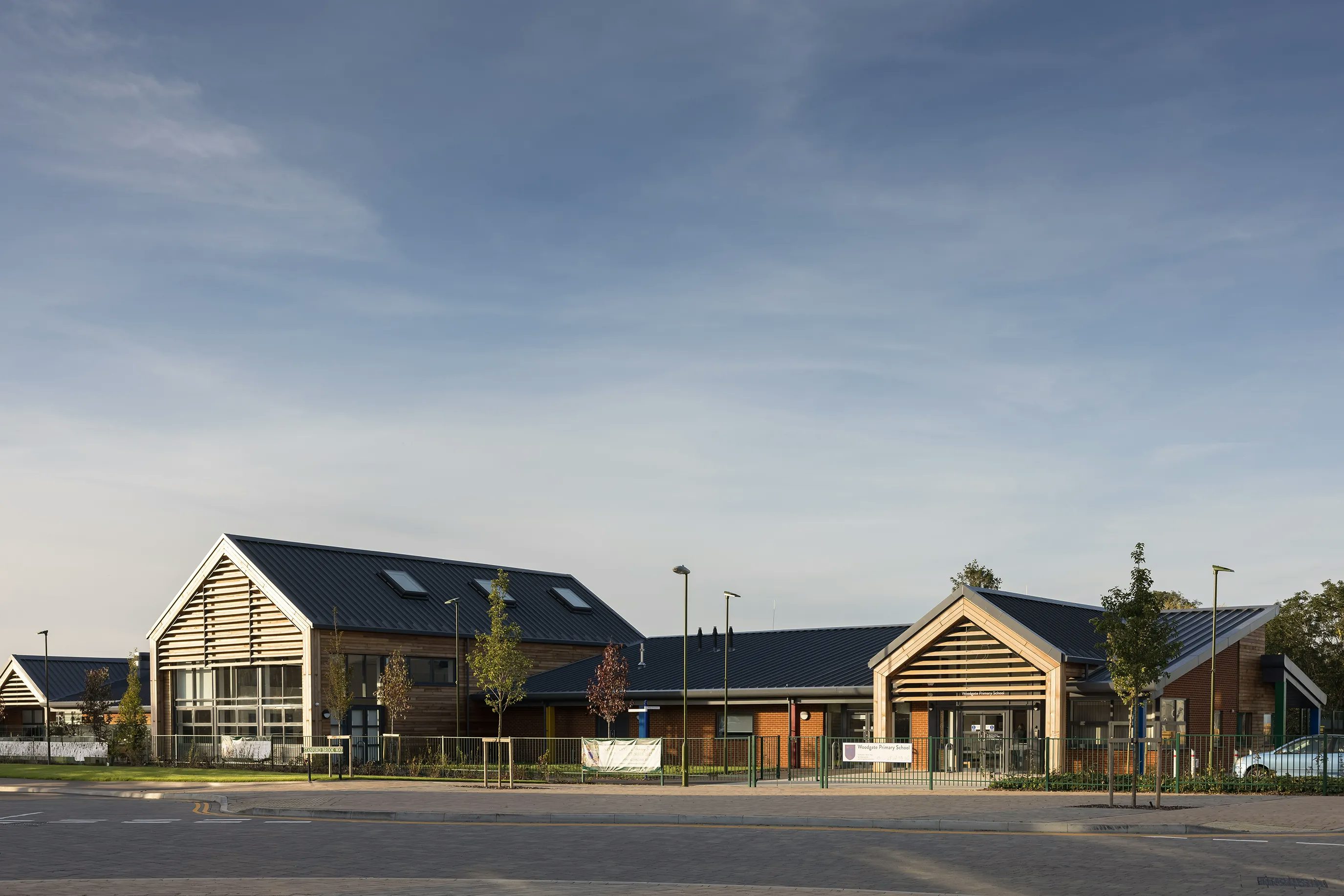 Image of the 4.1 million pound new primary school at Woodgate at Pease Pottage, delivered by Thakeham. Building is single storey and build in a modern style with wood and bricks.