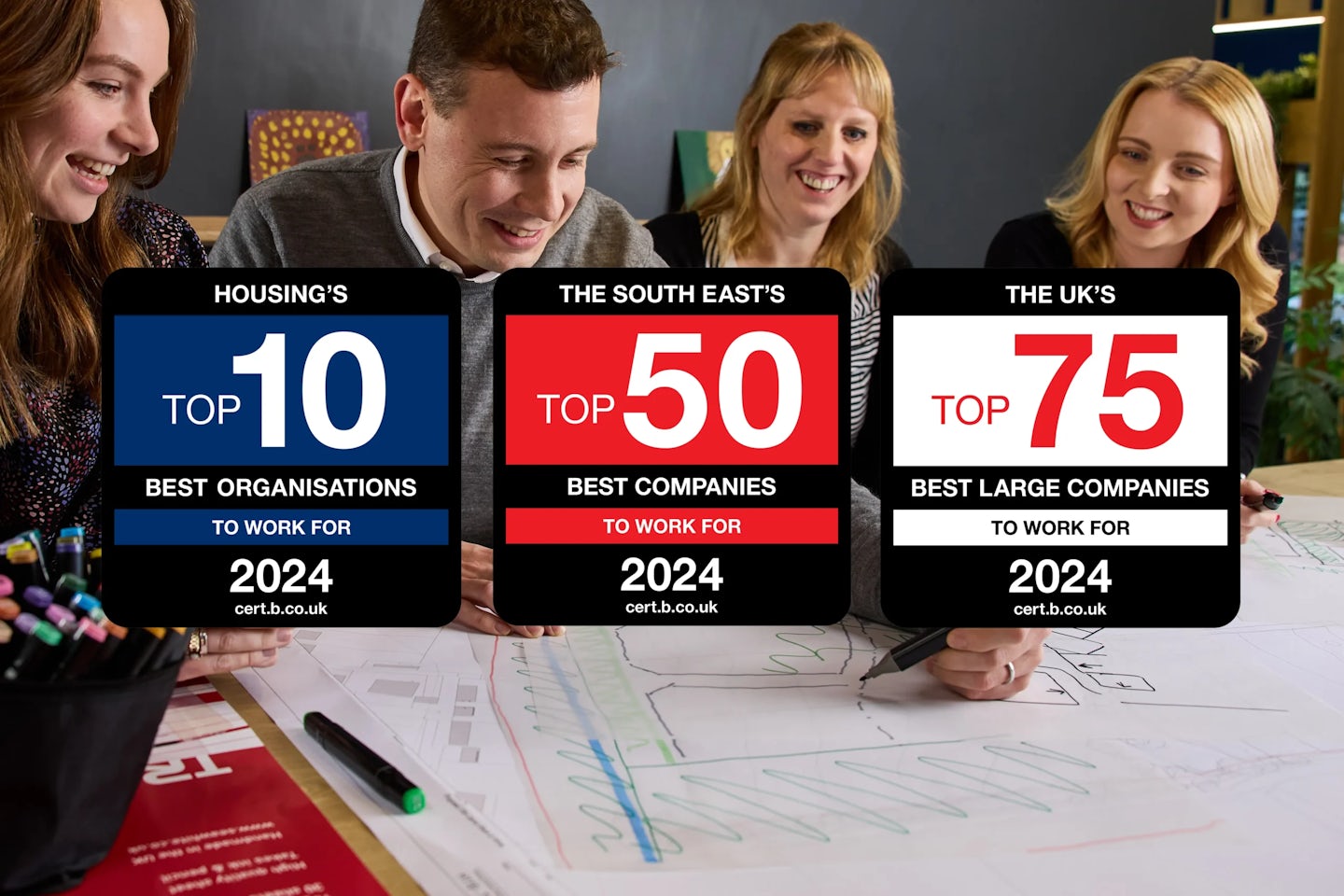 Four people are seated at a table, collaborating on a project. Their faces are blurred for privacy. Papers, a pen, and a marker are spread across the table. In front of them, three awards are prominently displayed, recognizing workplace excellence: - Housing's Top 10 Best Organisations to Work For 2024 (cert.b.co.uk) - The South East's Top 50 Best Companies to Work For 2024 (cert.b.co.uk) - The UK's Top 75 Best Large Companies to Work For 2024 (cert.b.co.uk) Let me know if you’d like any refinements!