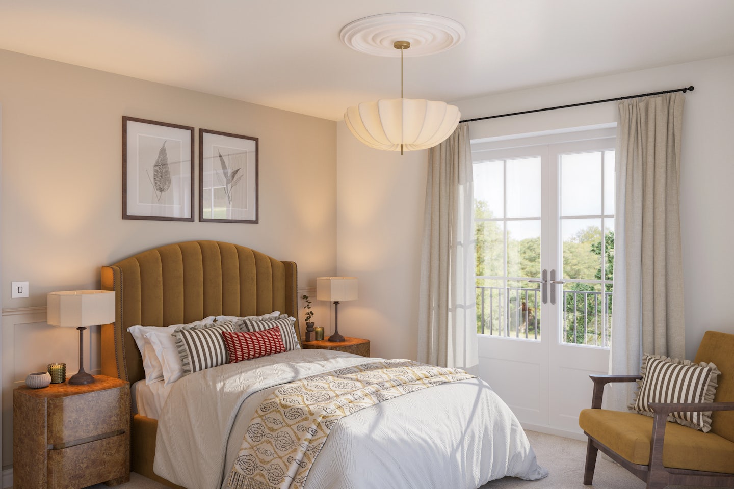 A softly lit, elegantly decorated bedroom with a mustard upholstered headboard, layered pillows, and a patterned throw. Wooden nightstands with lamps and ornaments frame the bed. Above it, two framed botanical prints add a natural touch. A striped cushion rests on a comfortable armchair in the corner. French doors open to a sunlit balcony with lush greenery, while a statement ceiling light anchors the tranquil space.