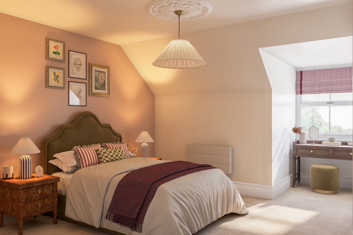 A softly lit bedroom featuring a large bed with a green upholstered headboard, neatly arranged pillows, and a draped blanket. Matching wooden nightstands with lamps and decorative accents flank the bed. Four framed artworks hang above, adding symmetry. To the right, a window with a striped valance lets in natural light, adjacent to a vanity-style desk with a mirror, stool, and assorted items. Warm beige tones, plush carpeting, and thoughtful decor create a calm, elegant atmosphere.