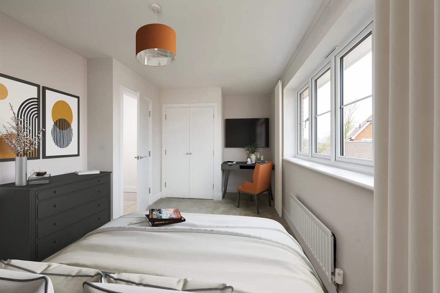 Modern minimalist bedroom with a white comforter on the bed, black dresser topped with decorative items, and two abstract framed artworks above. To the right, an orange desk chair sits at a workspace with a computer monitor, near a window with sheer white curtains. A door leads to another area, and natural light brightens the clean, organized space.