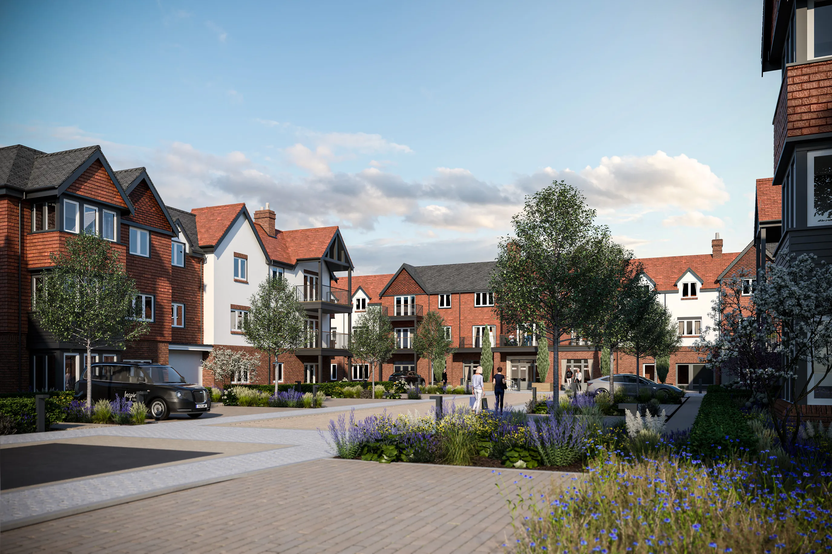 CGI of a modern residential courtyard featuring low-rise buildings with a mix of brick and white facades. The central landscaped area includes young trees, flowering plants, and pedestrian walkways. A few people are visible walking and talking, while cars are parked around the perimeter. The sky is partly cloudy, suggesting a pleasant, mild day.