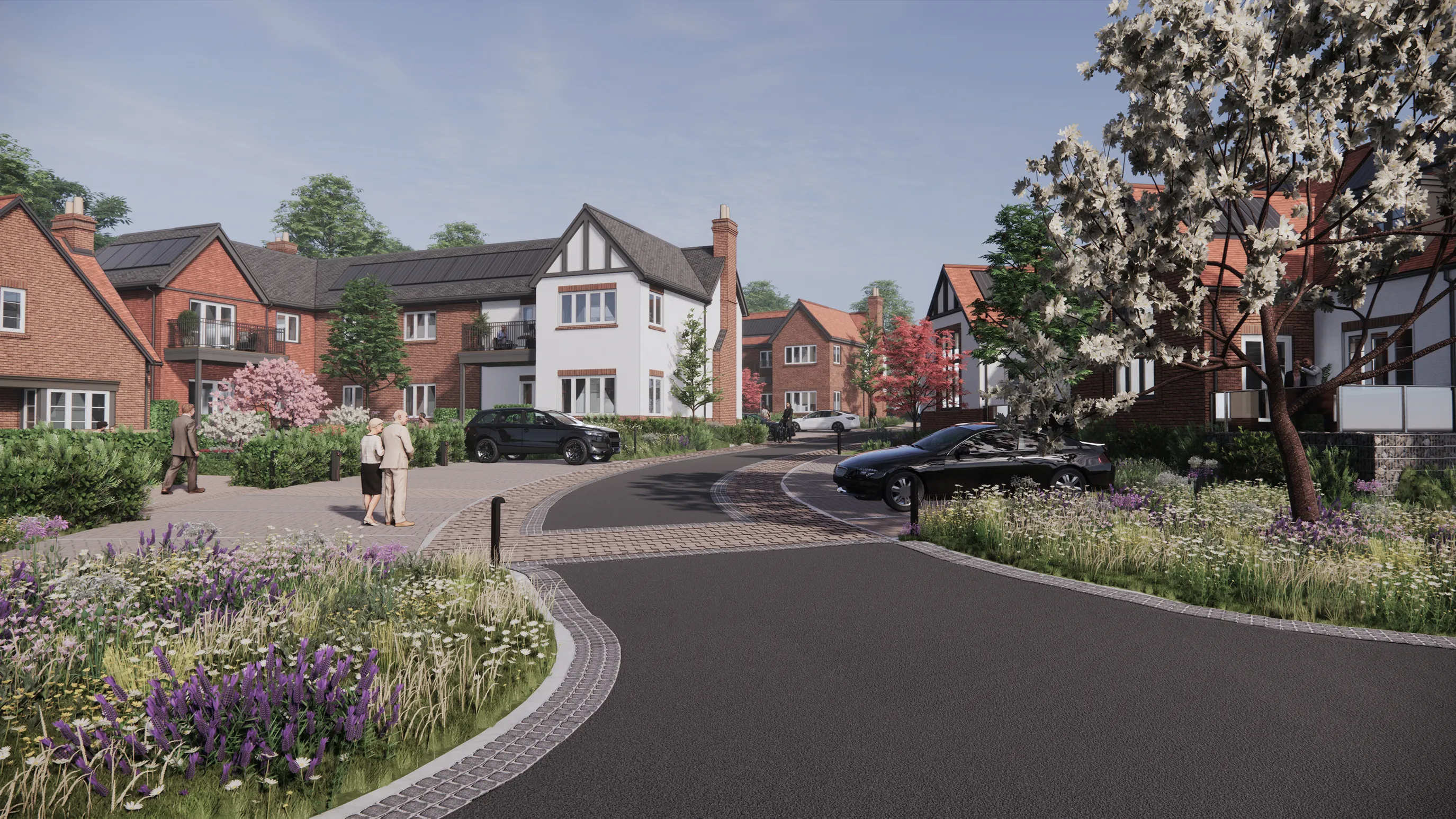 CGI of a well-kept residential street with modern brick and white houses, landscaped front gardens, and a few parked cars. People walk along the wide sidewalk, framed by flowering plants and greenery, suggesting a peaceful, community-oriented atmosphere.