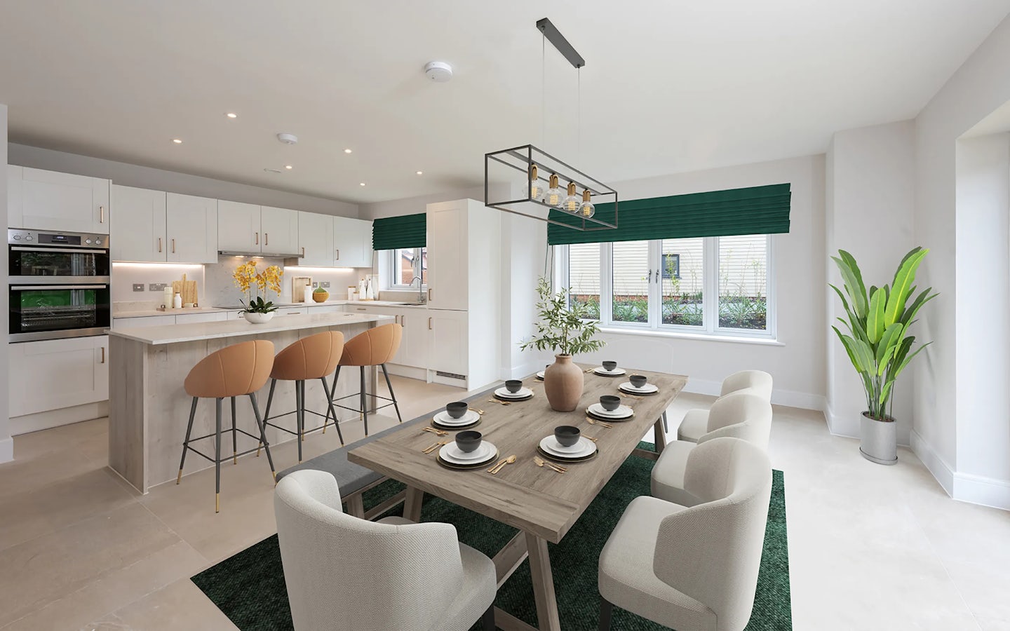 A contemporary kitchen and dining space featuring a large island with a light wood finish, surrounded by four bar stools. The kitchen includes sleek white cabinetry and a built-in oven. Adjacent is a wooden dining table set for six with white upholstered chairs. A potted plant near tall windows with green blinds adds a touch of greenery. A modern rectangular chandelier hangs above the dining area, and soft natural light enhances the neutral, minimalist decor.