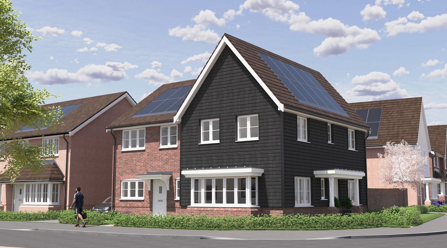 CGI of a modern suburban home with solar panels on a pitched roof, blending brick and black siding with white trim. Large windows face a sunny, well-kept garden, while a person strolls past on a quiet residential sidewalk. The clear blue sky adds to the peaceful, eco-conscious atmosphere.