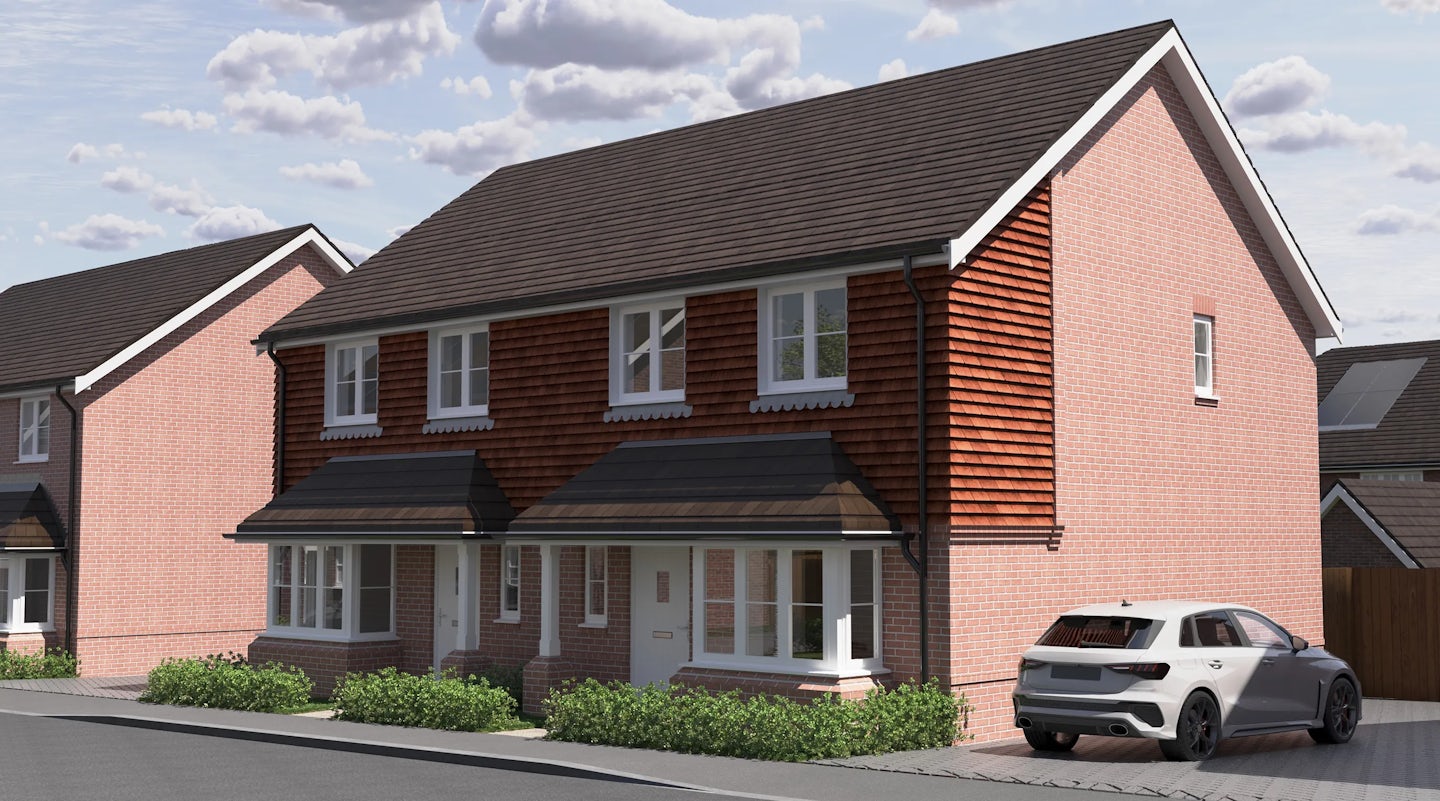 CGI of two semi-detached red brick homes with dark grey pitched roofs and white-framed windows, set along a quiet residential street. One home features a white car parked in a paved driveway. Small shrubs line the front gardens, and the partly cloudy sky lends a soft, temperate light to the peaceful suburban setting.