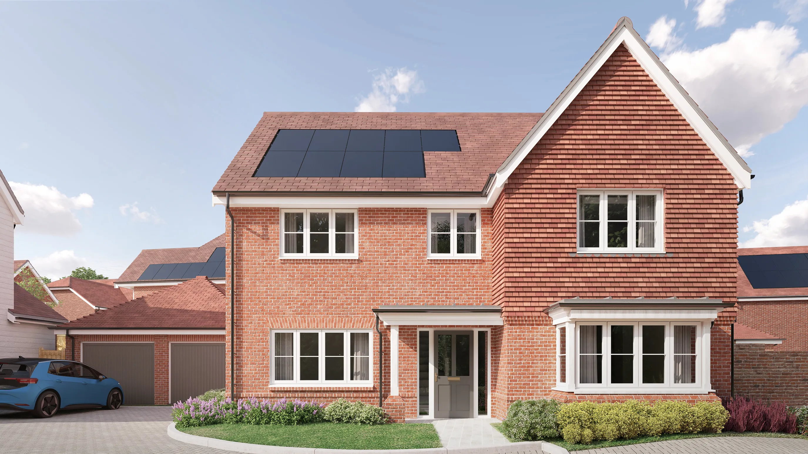 CGI of a modern two-story brick home featuring solar panels mounted on the red-tiled roof, showcasing a commitment to sustainability. The front façade includes a bay window on the ground floor, a garage to the left with a blue car parked in the driveway, and multiple white-framed windows adding balance and character. The well-maintained front garden features flowering plants and green shrubbery, softening the brickwork with natural charm. A sunny sky with scattered clouds enhances the inviting suburban atmosphere