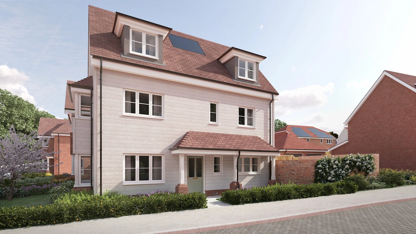 CGI of a modern three-story white house with a red-tiled roof and dormer windows on the top floor, blending traditional design with contemporary updates. The entrance features a small porch with brick pillars and a red-tiled canopy, adding character to the symmetrical façade. Multiple white-framed windows punctuate the walls, while lush landscaping—including a tree with purple flowers and neatly trimmed bushes—softens the architecture. In the background, similar houses with solar panels reinforce a cohesive, eco-aware neighbourhood aesthetic.