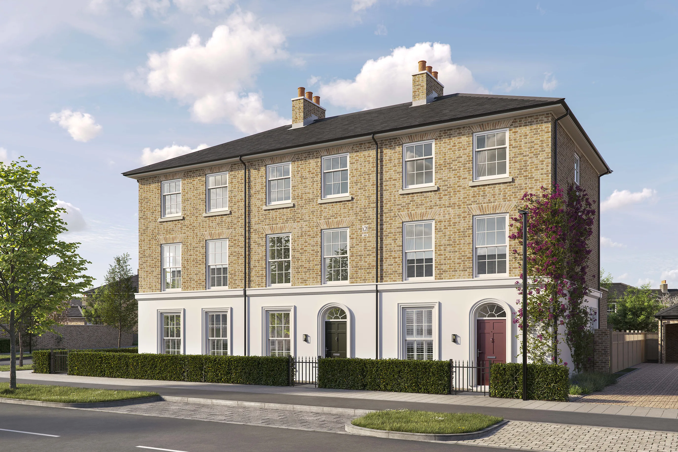 Three-story brick townhouse with a pitched roof and white-framed sash windows. The ground floor features a white-painted facade with three arched doorways, two with black doors and one with a red door. Low hedges and black railings border the front of the property, and a tall flowering vine climbs the right side of the building. The house is situated on a paved street with a young tree in the foreground under a bright blue sky with scattered clouds.