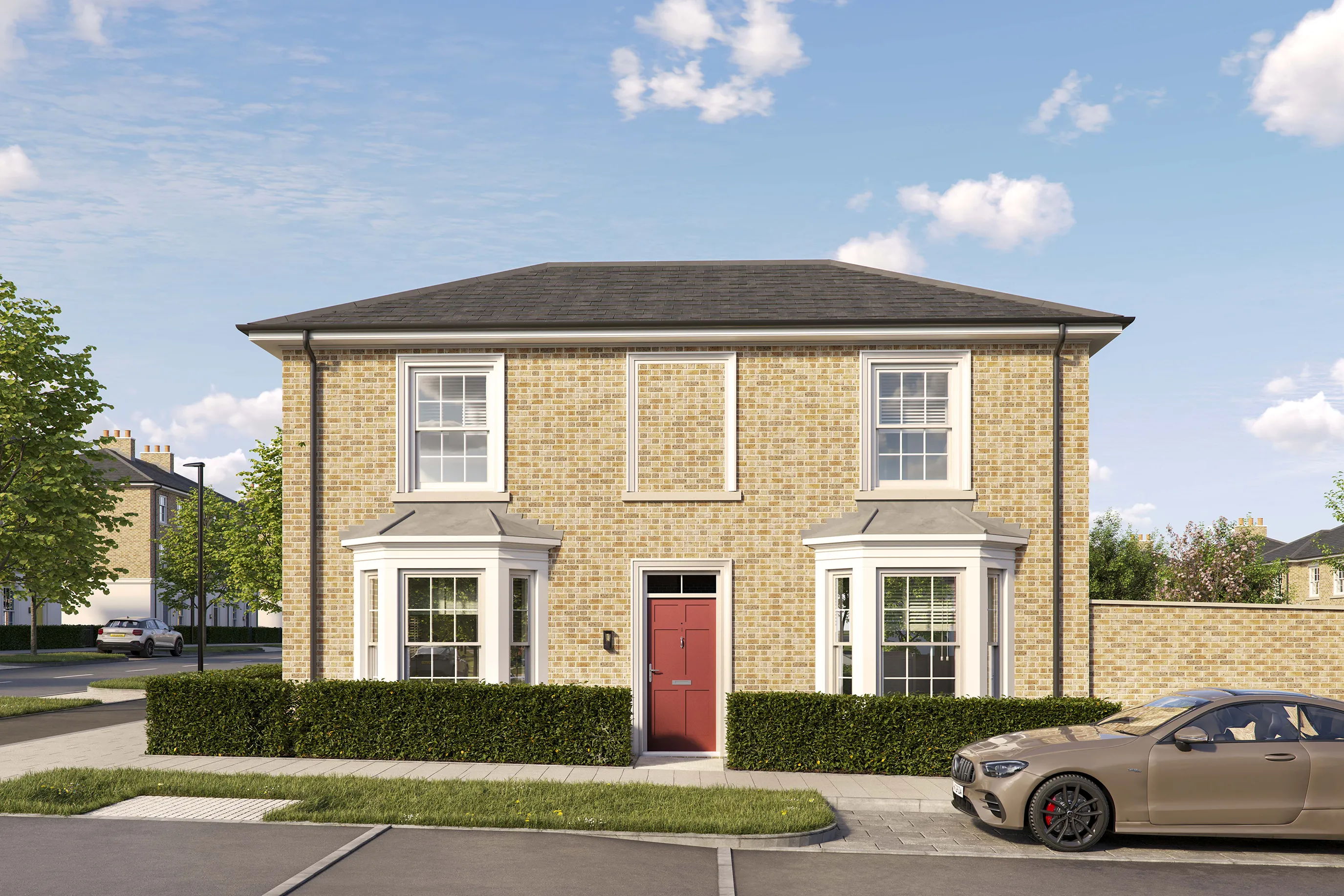 Two-story detached brick house with a pitched roof and white-framed sash windows. The front features a central red door with a small canopy and two bay windows on either side. A low hedge borders the property, and a tan car is parked on the driveway to the right. The house is set on a quiet residential street under a bright blue sky with scattered clouds.