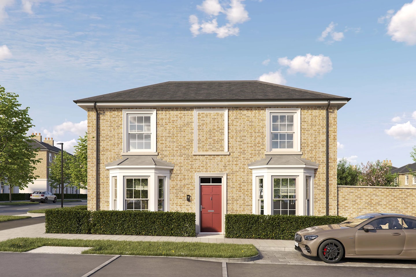 Two-story detached brick house with a pitched roof and white-framed sash windows. The front features a central red door with a small canopy and two bay windows on either side. A low hedge borders the property, and a tan car is parked on the driveway to the right. The house is set on a quiet residential street under a bright blue sky with scattered clouds.