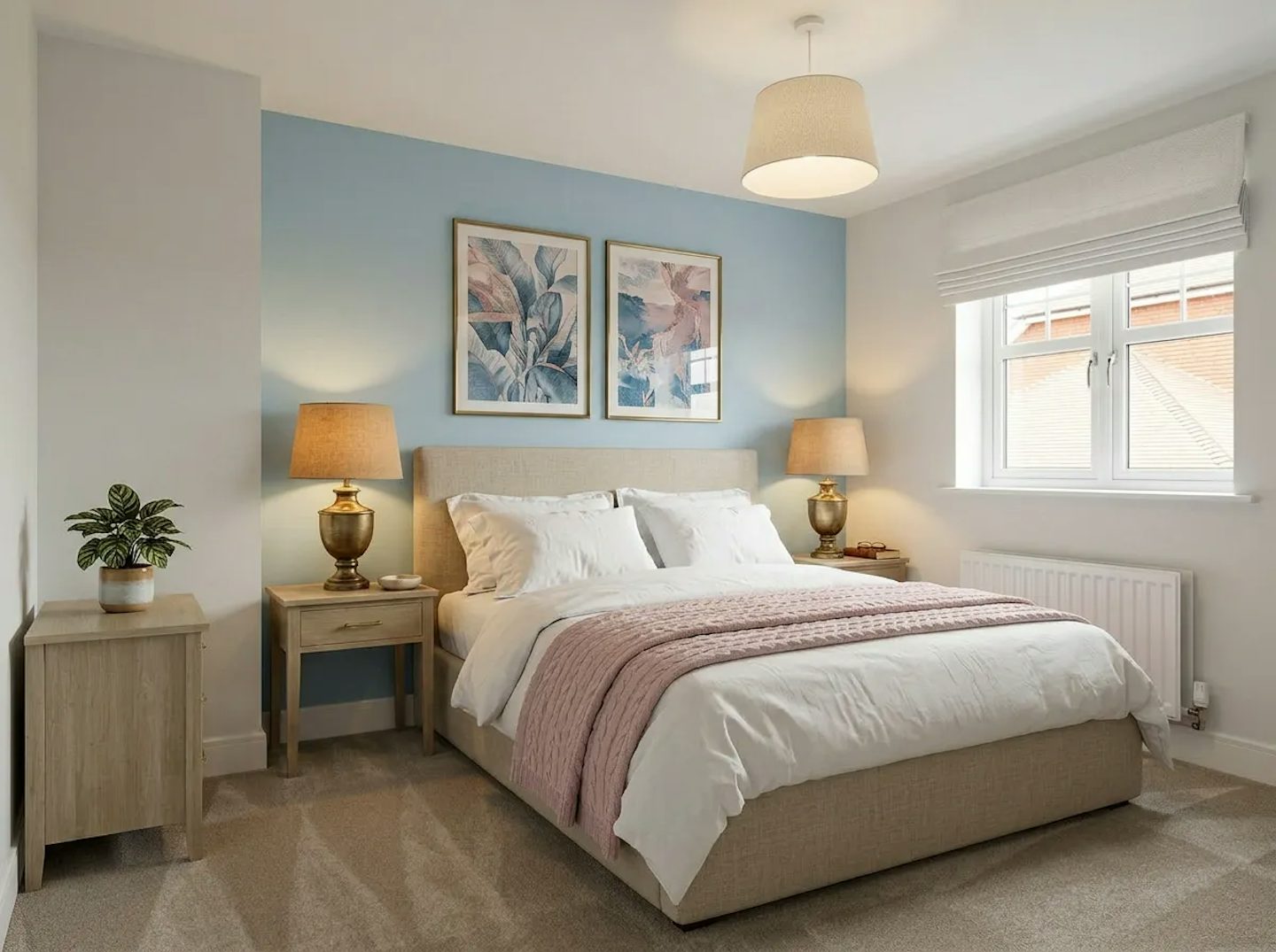Bedroom with double bed, bedside tables and lamps, blue feature wall with framed artwork, and a window with blinds.