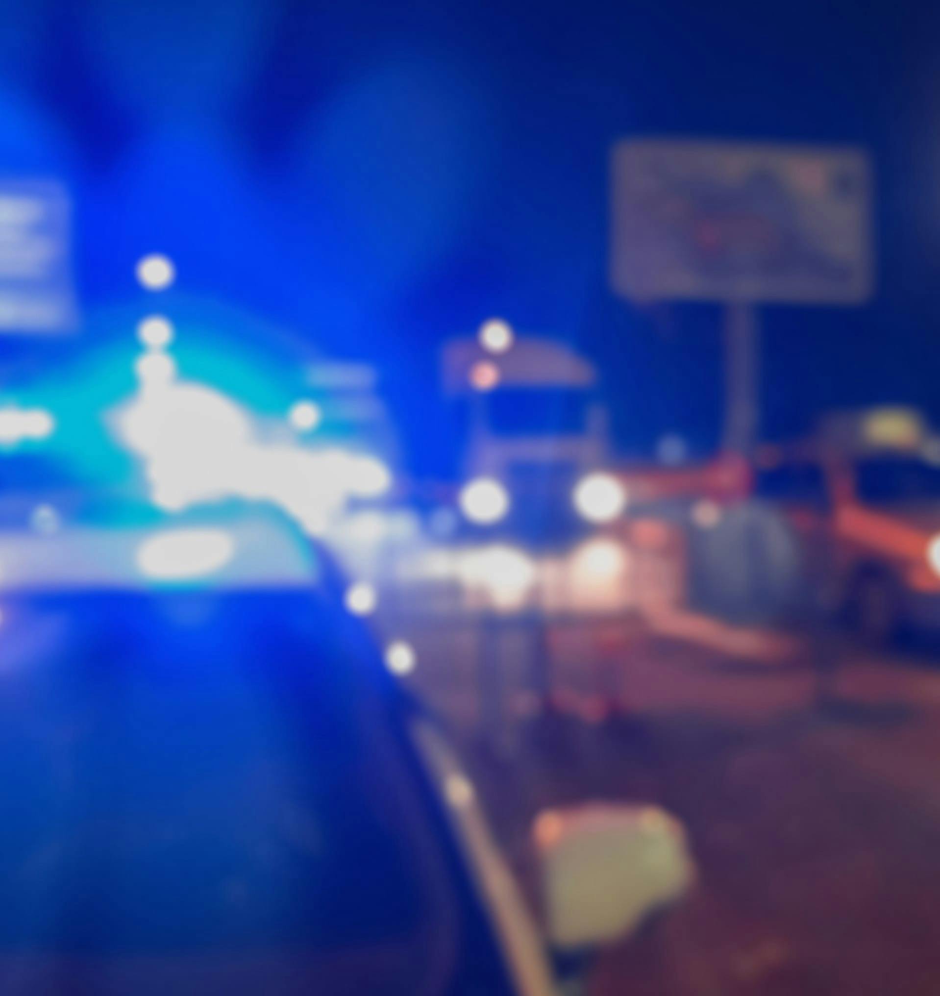 Blurry photo of a crime scene with police lights
