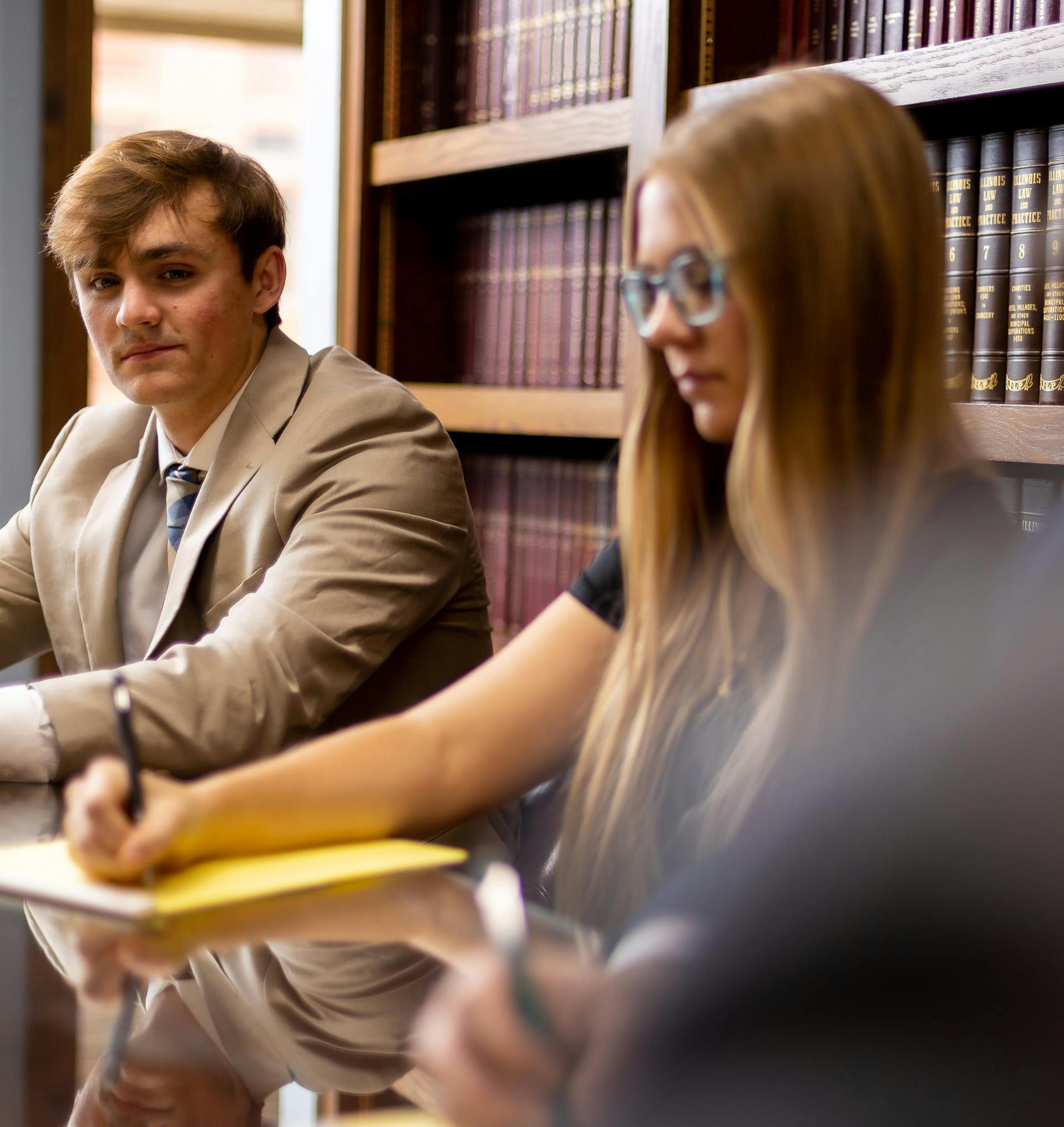 Two staff of Hanauer Law working at a table.