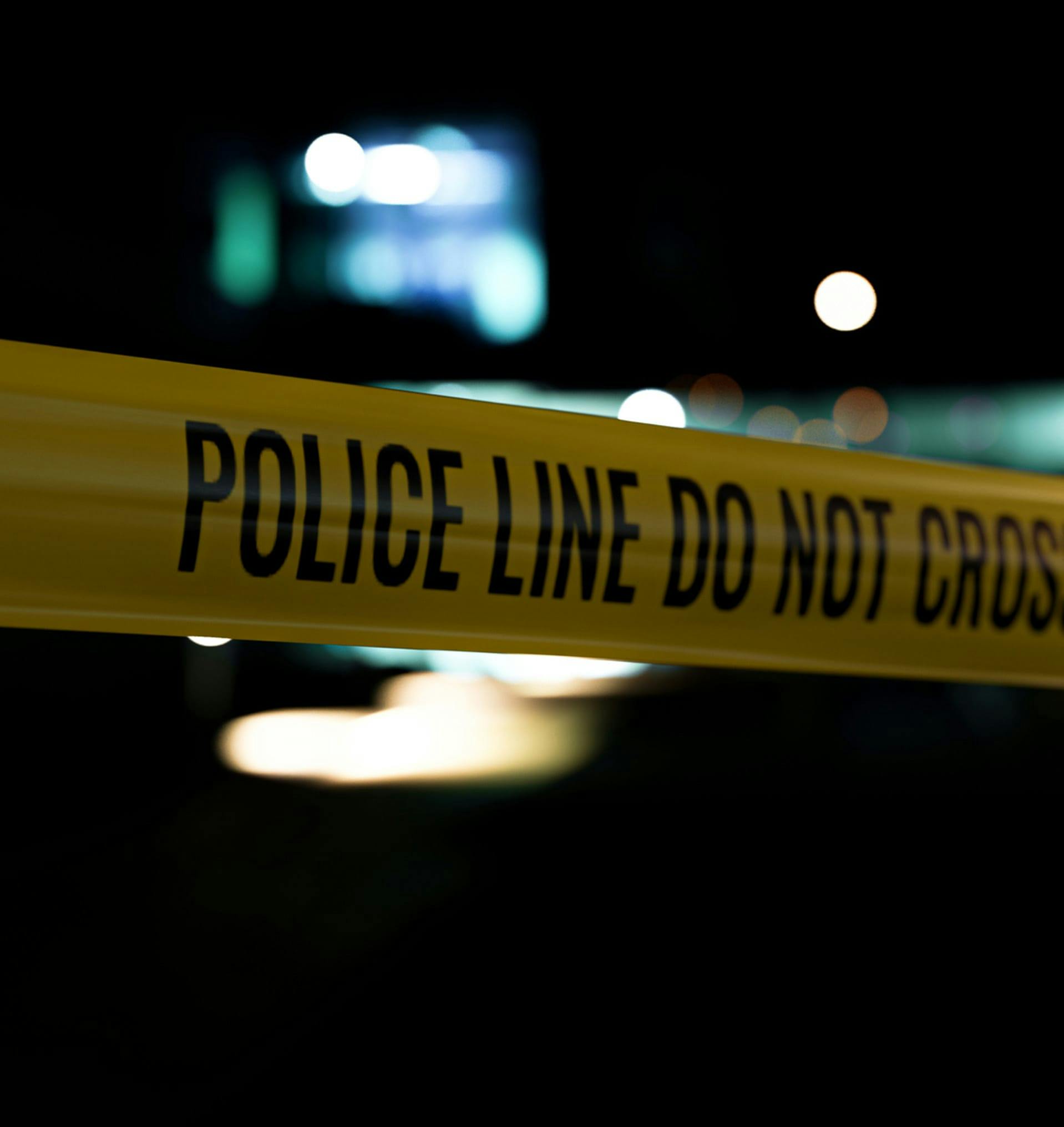 Closeup of tape that says Police Line Do Not Cross