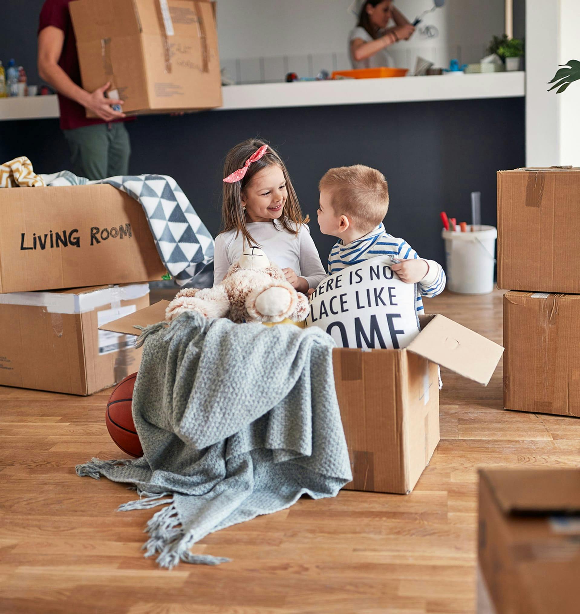 Two kids unboxing moving materials.