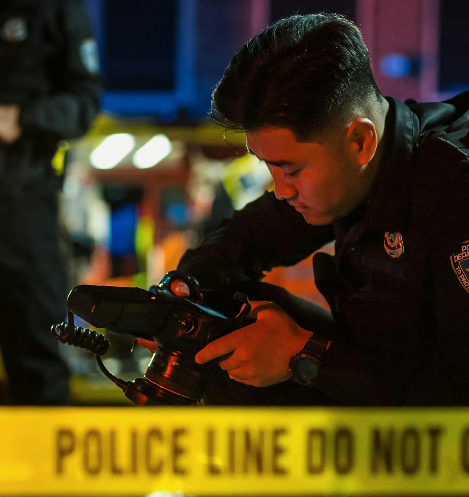 Police officer taking photos at a crime scene.