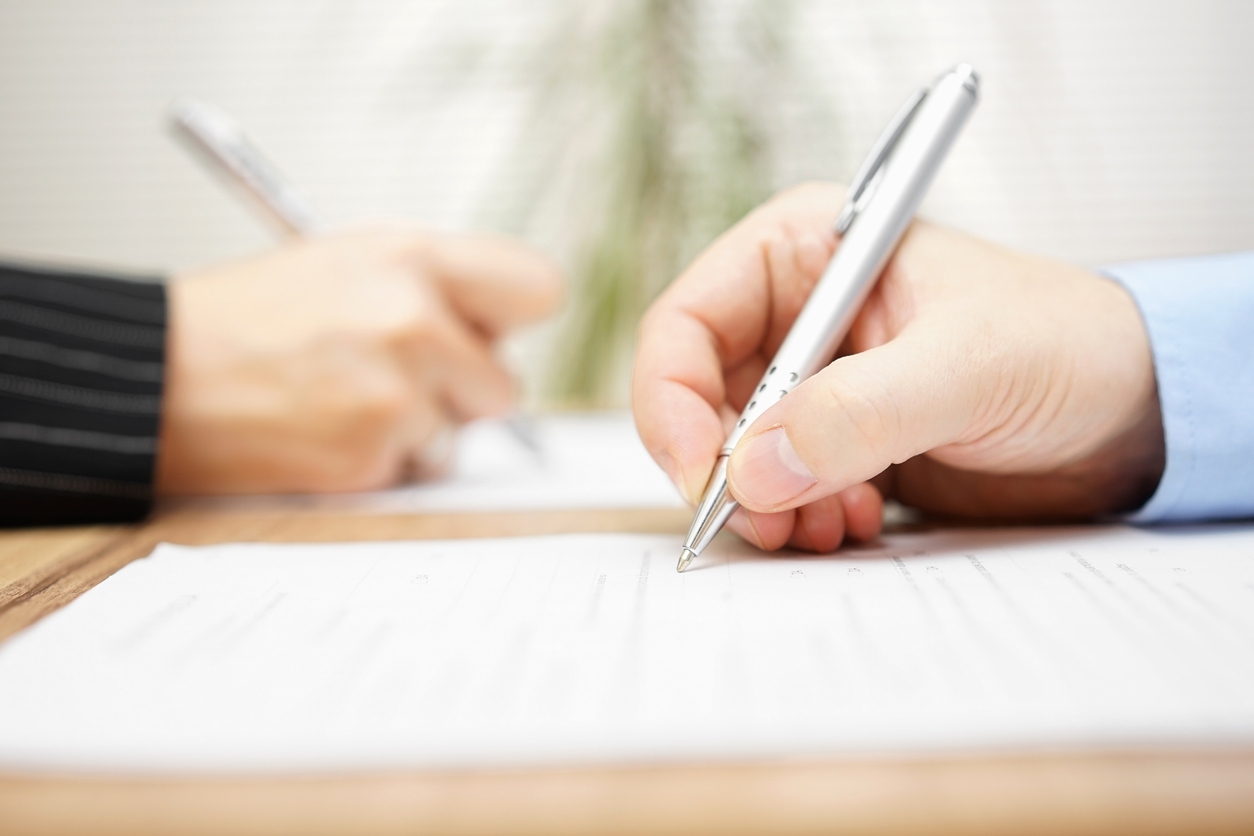 People signing a document