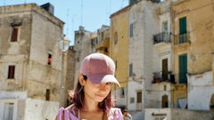 woman wearing pink fitted cap in city