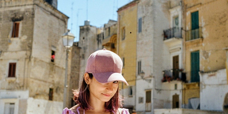 woman wearing pink fitted cap in city