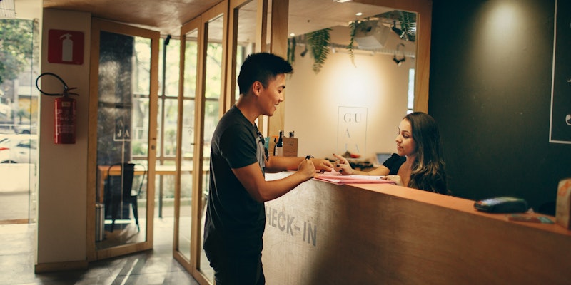 man in black shirt standing beside counter