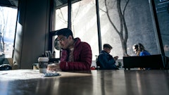 man sitting on brown table
