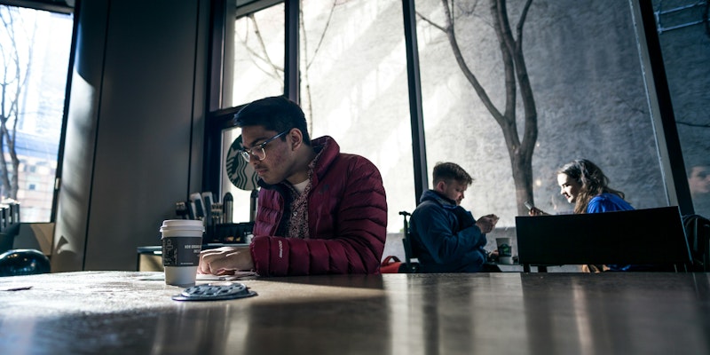 man sitting on brown table