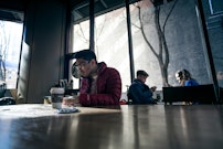 man sitting on brown table