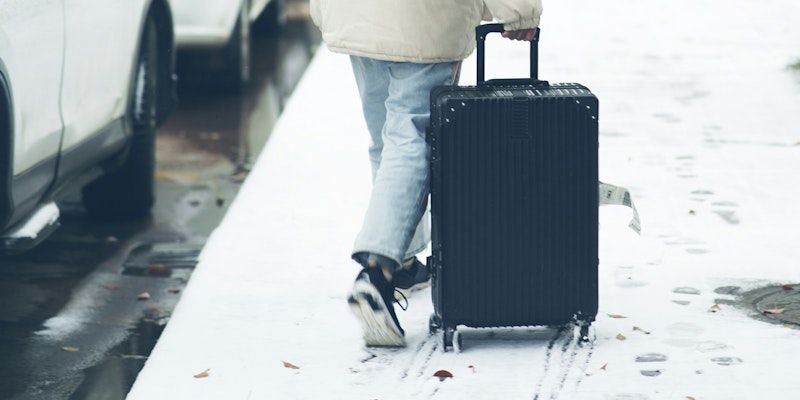 a person pulling a suitcase
