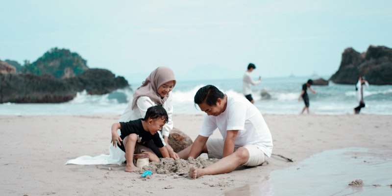 a group of people playing on a beach