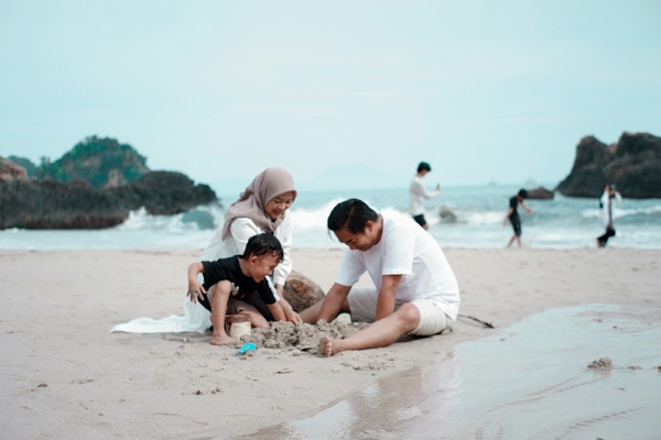 a group of people playing on a beach