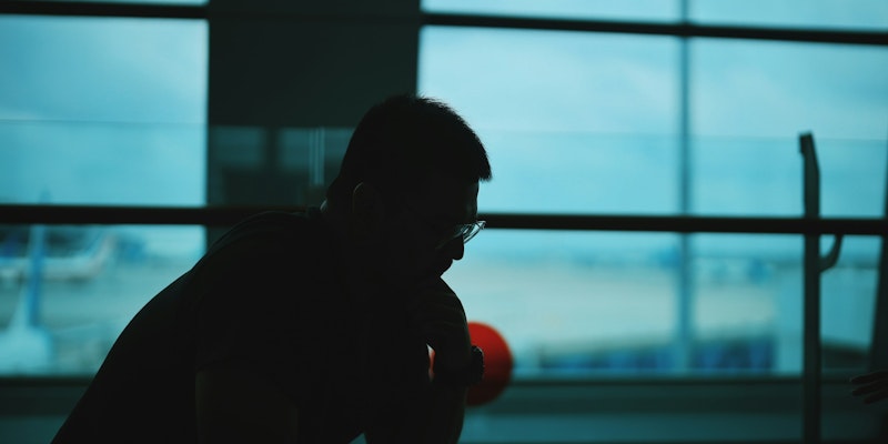 silhouette of man sitting on chair