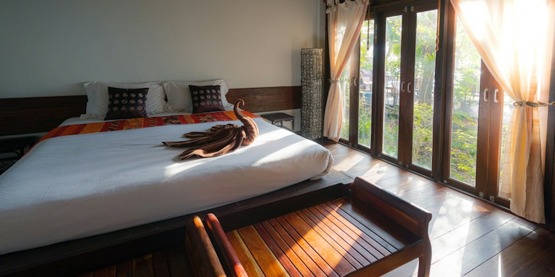 white bed linen with brown wooden bed frame