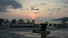 man in pool during golden hour