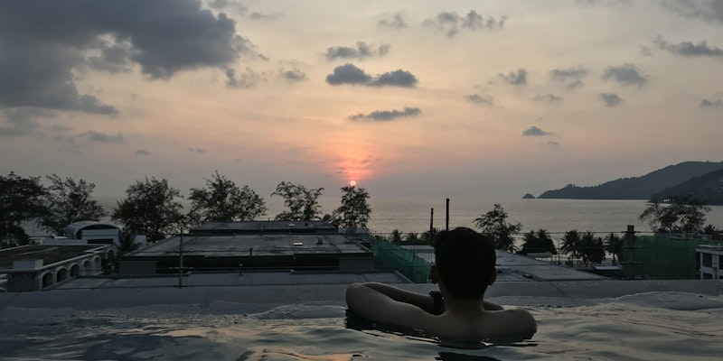 man in pool during golden hour